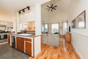 A modern kitchen with a central island, wooden cabinets, and a built-in oven. - Farm Cottage in Sequim w/ Fenced Orchard (Sequim)
