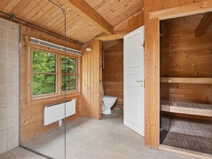 A wooden interior with a window, a white toilet, and a door leading to a loft space. - "Greta" - 1.7km from the sea by Interhome (Rørvig)