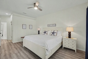A bedroom with a bed, bedside tables, a ceiling fan, and wall art. - 3BR Pool Home in Lely Resort Near Beaches & Golf...The Players Club & Spa Avail (Naples)