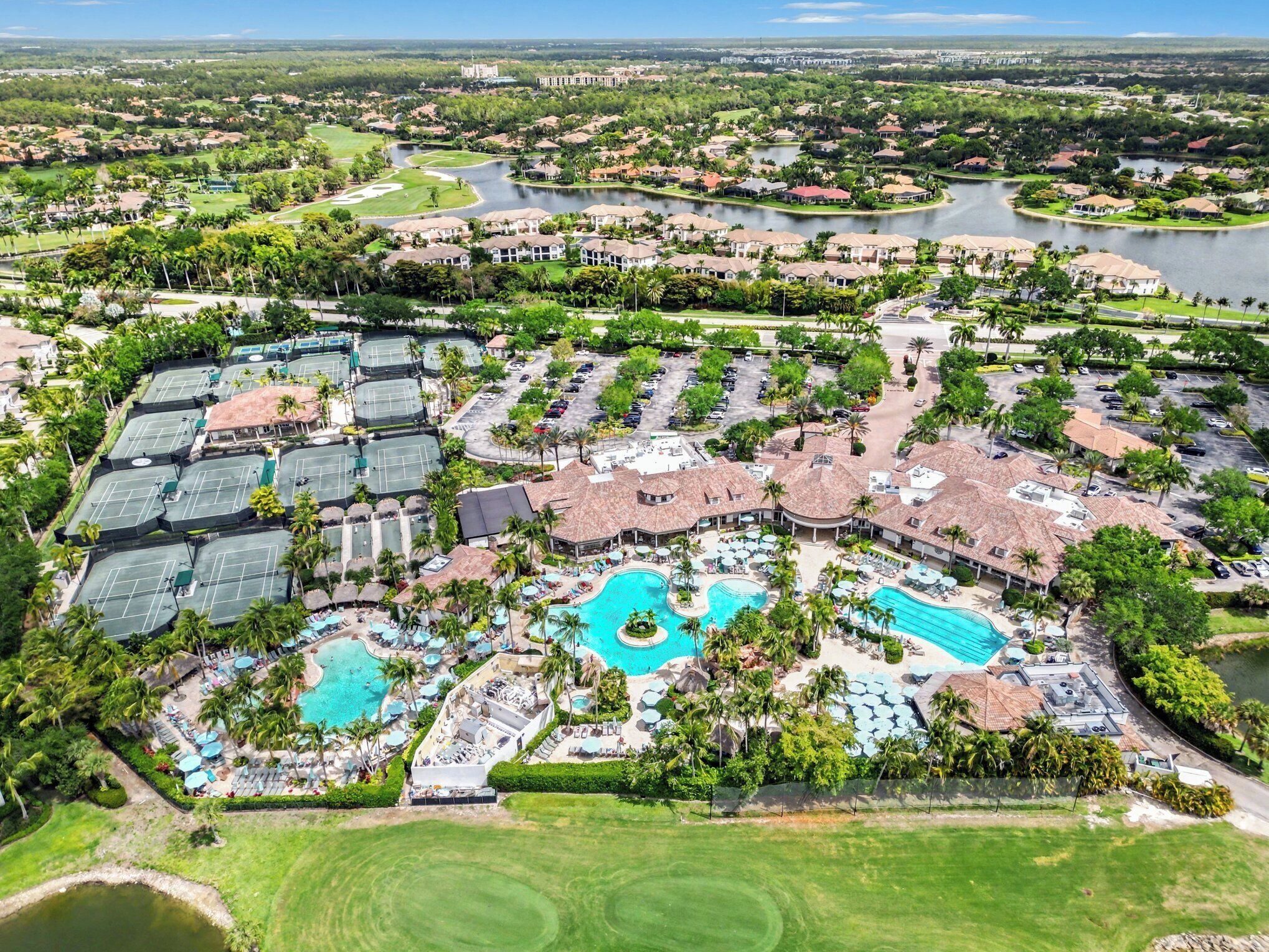 A resort with multiple swimming pools, tennis courts, and a golf course.