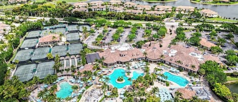 A resort with multiple swimming pools, tennis courts, and a golf course.