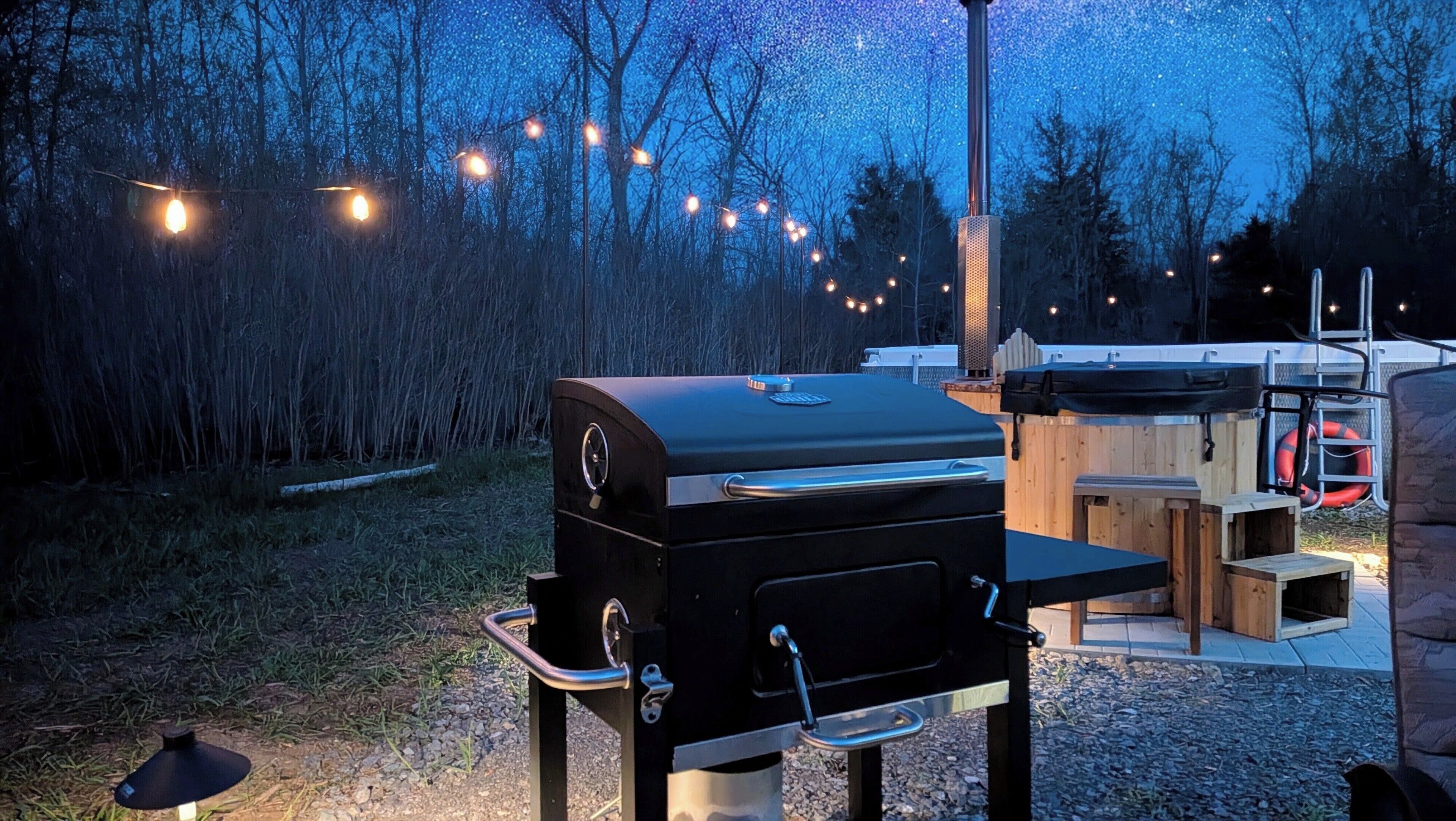 A barbecue grill, outdoor seating, and a wooden deck.