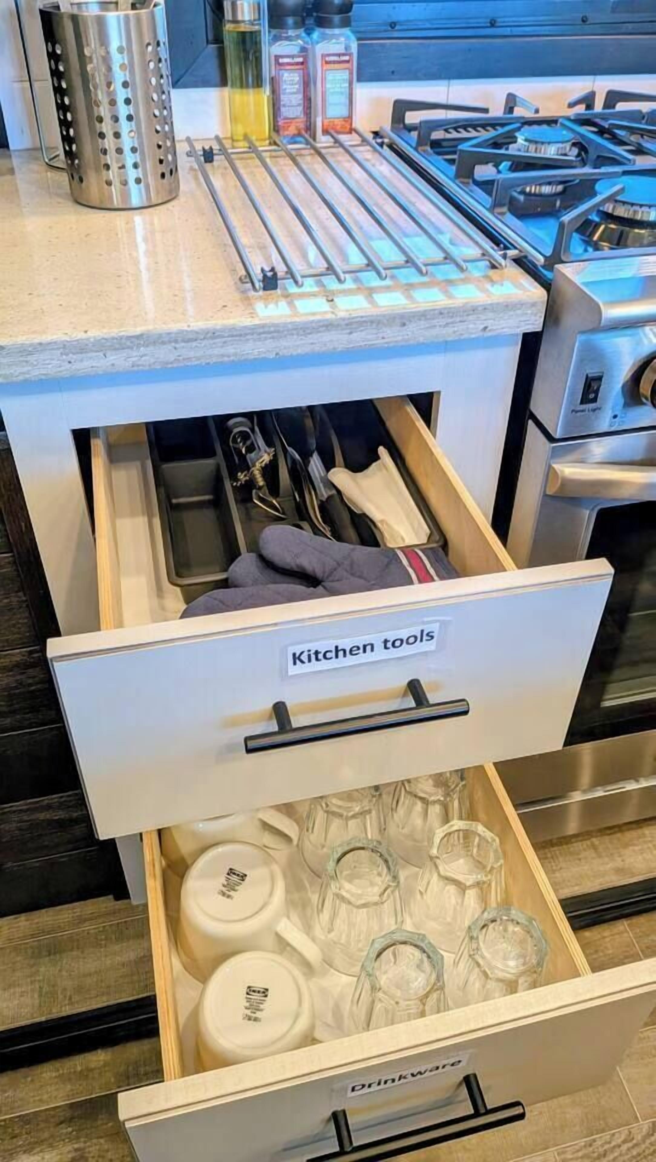 A kitchen drawer with a label 'Kitchen tools' containing various utensils and cookware.