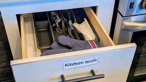 A kitchen drawer with a label 'Kitchen tools' containing various utensils and cookware.