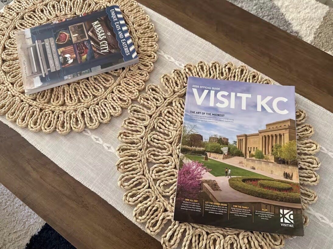 A book titled 'VISIT KC' on a woven placemat.