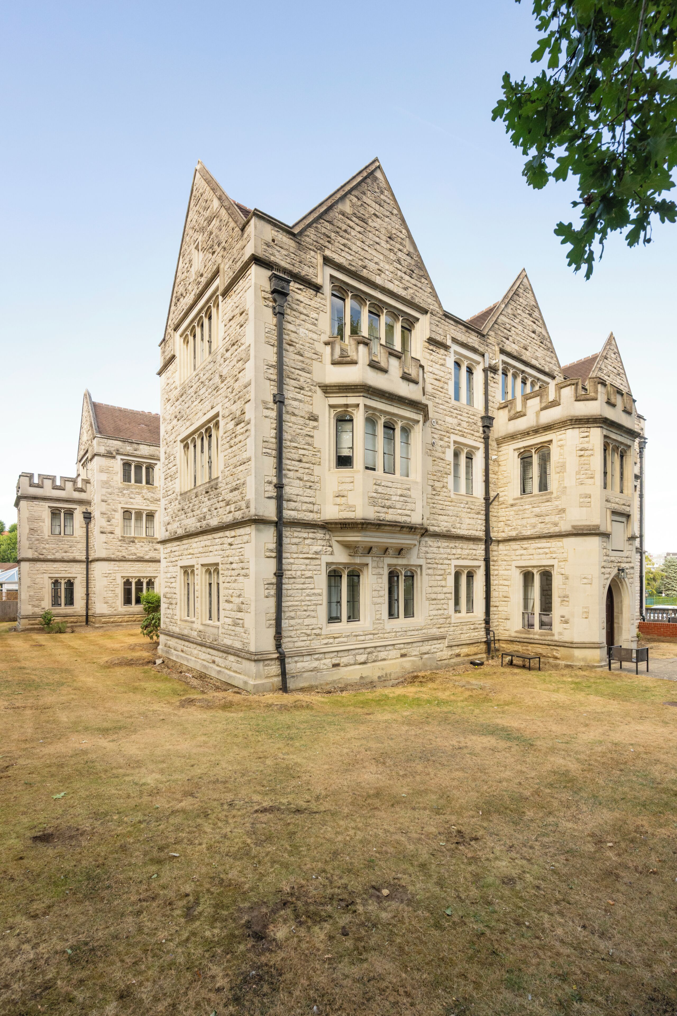 A large stone building with multiple towers and arched windows.