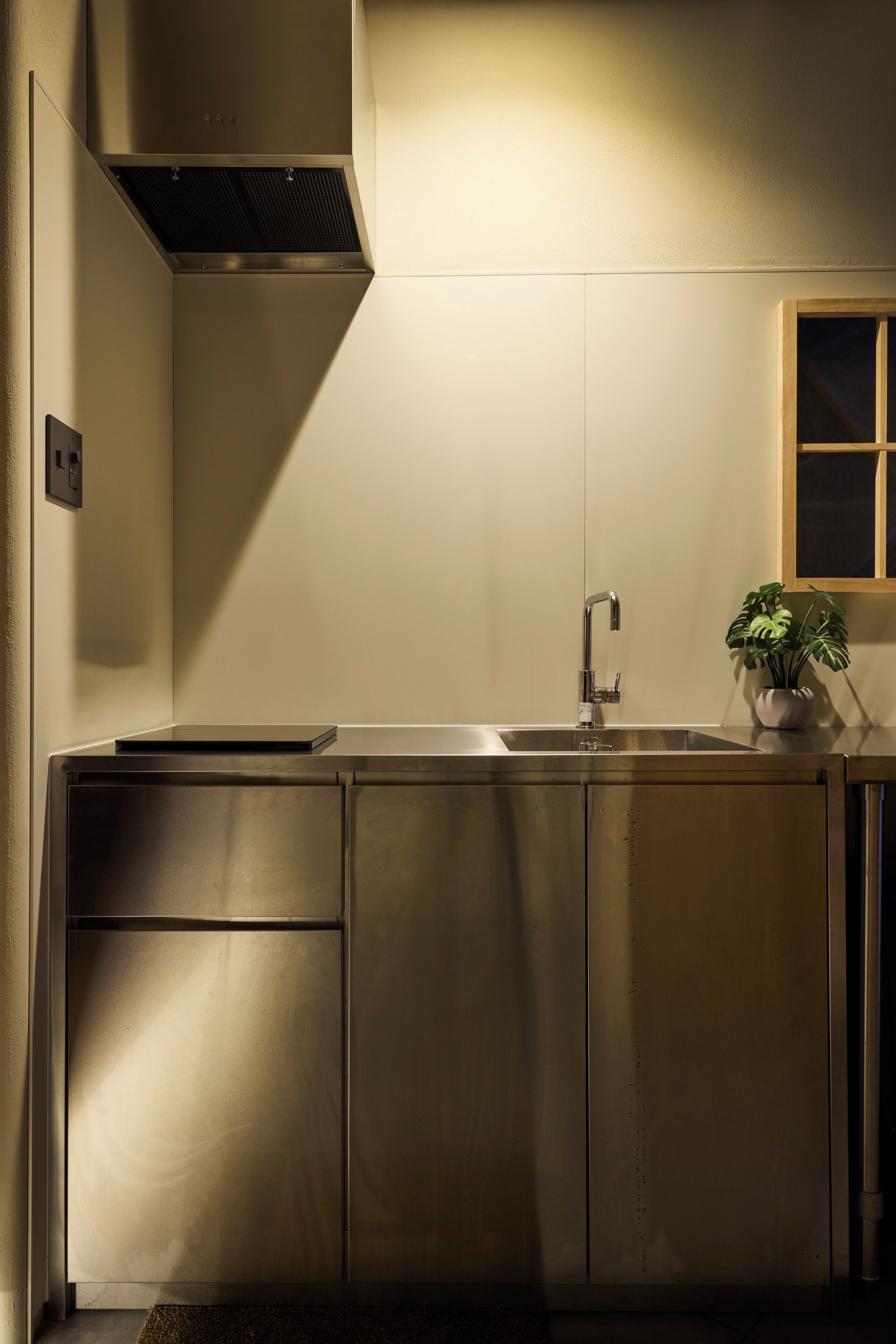 A modern kitchen with stainless steel appliances, a built-in sink, and a window above the sink.