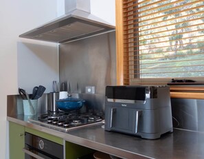 A kitchen with a stove, a blue pot, and a Toefal air fryer. - Breathtaking Views - 3 Bedroom House (Gordon)