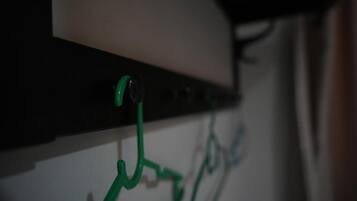 A close-up of a wall-mounted electrical panel with green cables connected to it.