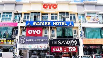 A hotel with a prominent 'AVATAR HOTEL' sign, a 'YOYO' logo, and a 'SEE STW' sign.