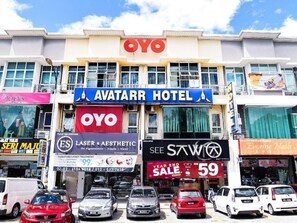 A hotel with a prominent 'AVATAR HOTEL' sign, a 'YOYO' logo, and a 'SEE STW' sign.