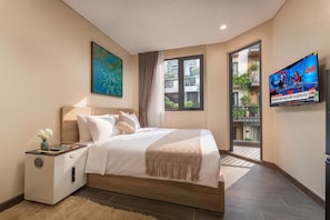 A modern bedroom with a bed, bedside table, and a TV displaying news.