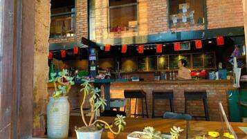 A restaurant with a brick facade, outdoor seating, and a bar area.