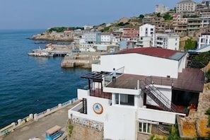 A coastal building with a white facade, a red roof, and a view of the sea. - Dongji Inter national Youth Hostel (Zhoushan)