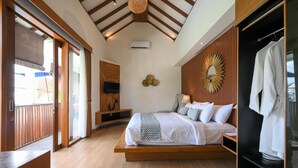 A bedroom with a bed, bedside tables, a wardrobe, and a large mirror.