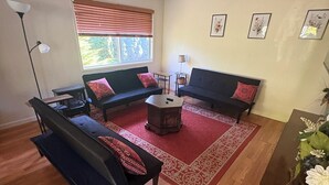 A living room with two sofas, a coffee table, and a floor lamp.