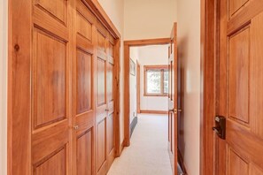 A hallway with wooden doors and a window at the end. - Edwards 4BR, Hot Tub,  Mountain Views & Near Vail (Edwards)