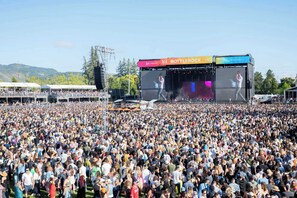 Um grande concerto ao ar livre com palco e público.