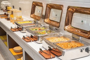 A buffet with multiple food stations, including pasta, rice, and vegetables. - Licheng Donggu Hotel (Cangzhou)