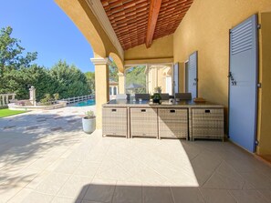 An outdoor patio area with a covered seating area, a pool, and a view of the surrounding landscape. - Beautiful villa with pool and close to a village (Lorgues)