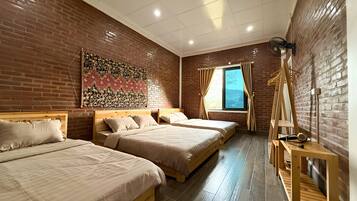 A room with two wooden beds, a brick wall, a window with curtains, and a wooden ladder.