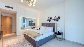A modern hotel room with a large bed, bedside tables, a mirror, and a unique wall art piece. - Full Burj Khalifa View, Central Dubai, Furnished (Dubai)