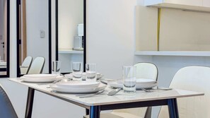 A dining table set with plates, glasses, and cutlery in a modern interior. - Full Burj Khalifa View, Central Dubai, Furnished (Dubai)