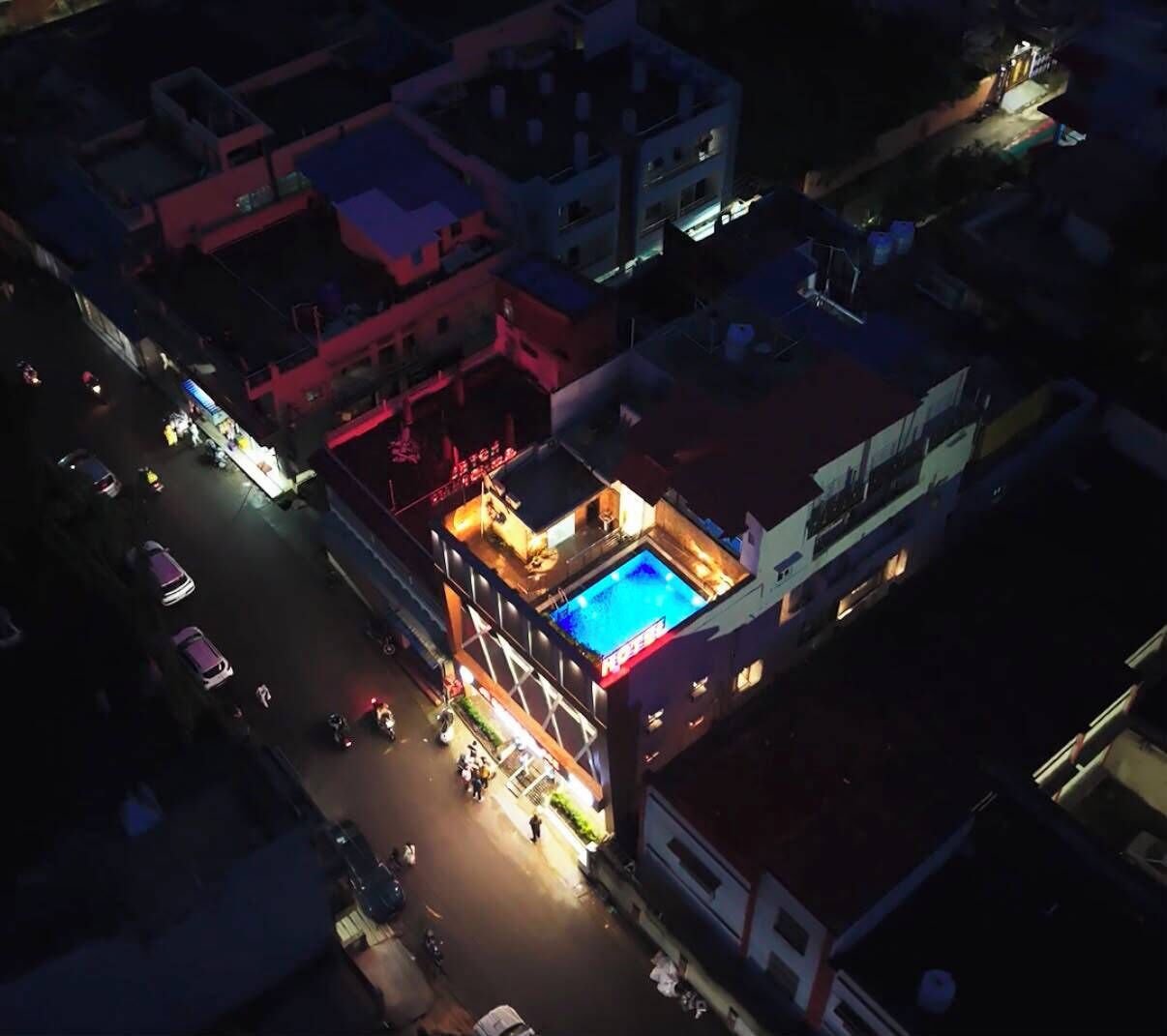 A multi-story building with a rooftop pool area.