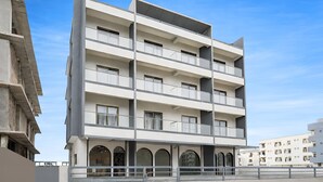 A multi-story building with balconies, large windows, and a flat facade. - Axon Business Hotel Sanand Ahmedabad (Ahmedabad)