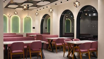 Un interior de restaurante con cabinas, mesas y sillas.
