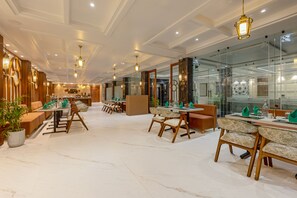 A hotel lobby with marble flooring, wooden furniture, and modern lighting fixtures. - Sterling Regalia Agra (Agra)