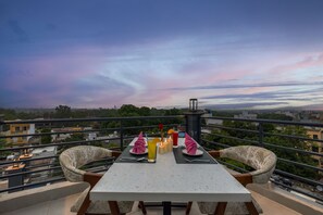 A dining table with chairs and a view of the cityscape. - Sterling Regalia Agra (Agra)