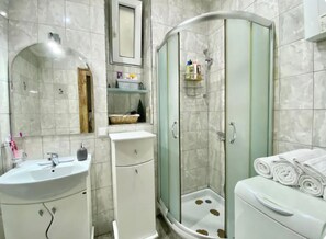 A bathroom with a sink, mirror, vanity, shower enclosure, and a toilet. - Square 29,Stari grad
two minutes to Skadarlija (Beograd)