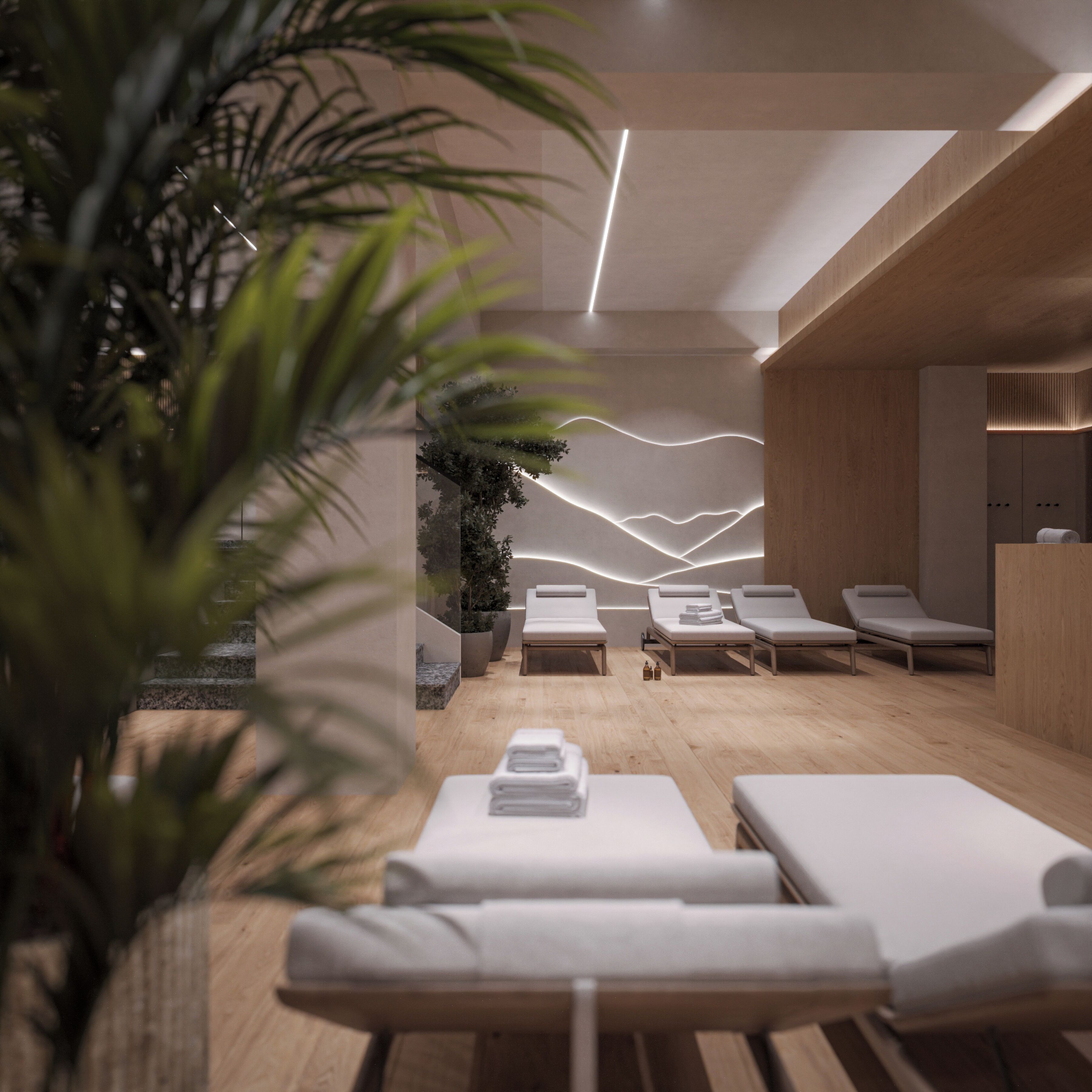 A modern spa room with wooden flooring, white lounge chairs, and a wall with a light wave design.