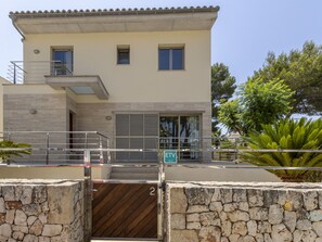 A two-story building with a stone wall entrance, a metal gate, and a sign indicating 'ETV'. - Villa Albufera by Interhome (Platja de Muro)