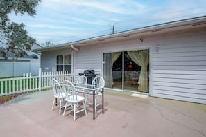 A house with a covered patio, a grill, and a fenced yard. - Golf, Beach, Parks! Palm Coast Family Home w/ Yard (Palm Coast)