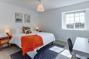 A bedroom with a bed, two bedside tables, a window, and a view of the outdoors. - Heated Pool, Spa & Game Room: Yucca Valley Retreat (Yucca Valley)