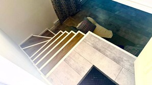 A staircase with a patterned carpet and a patterned wall.