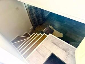 A staircase with a patterned carpet and a patterned wall.