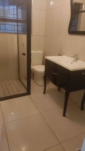 A bathroom with a toilet, a sink, and a shower area. - Serene Guest Room Retreat Near Cape Town Airport (Cape Town)