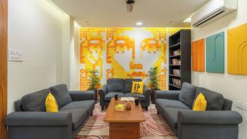 A living room with two grey sofas, a wooden coffee table, and a patterned rug.