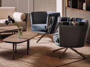 A living room with a sofa, a chair, a coffee table, and a rug.