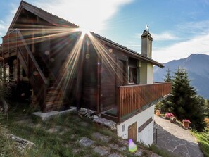 A wooden cabin with a steeply pitched roof, a chimney, and a wooden deck. - Carpe Diem Appartement/Fewo, Dusche und Bad, WC 3 1/2 Zimmerwohnung, 6-Betten by Interhome (Riederalp)