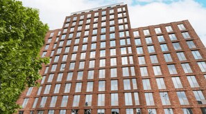 A multi-story building with a grid of windows and a flat roof.