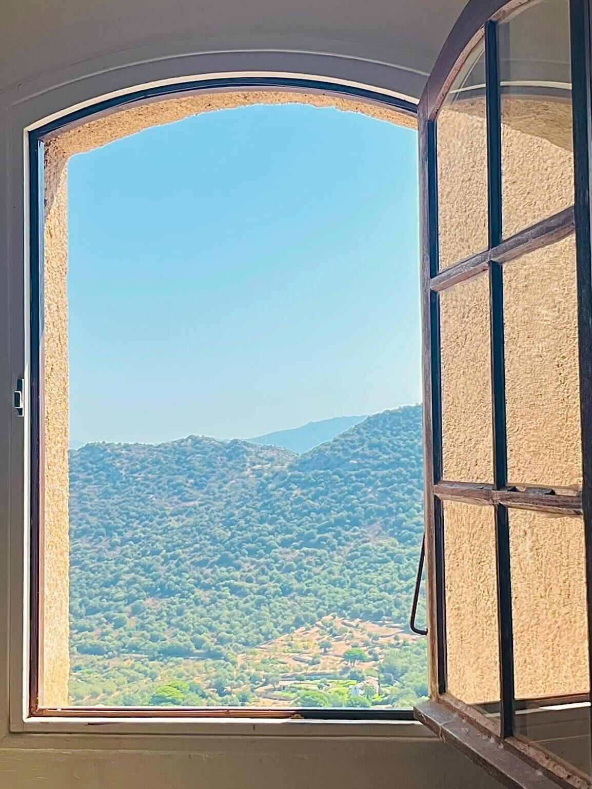 Una ventana con vistas a un paisaje montañoso.