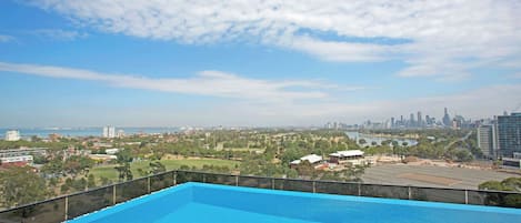 A swimming pool with a cityscape view.