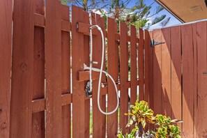 A wooden fence with a hose attached to it. - Spacious two-story 2BR, 3-bath beachside condo with a private patio and upstairs balcony. Just a short drive, bike or golf cart ride to the beach. (New Smyrna Beach)