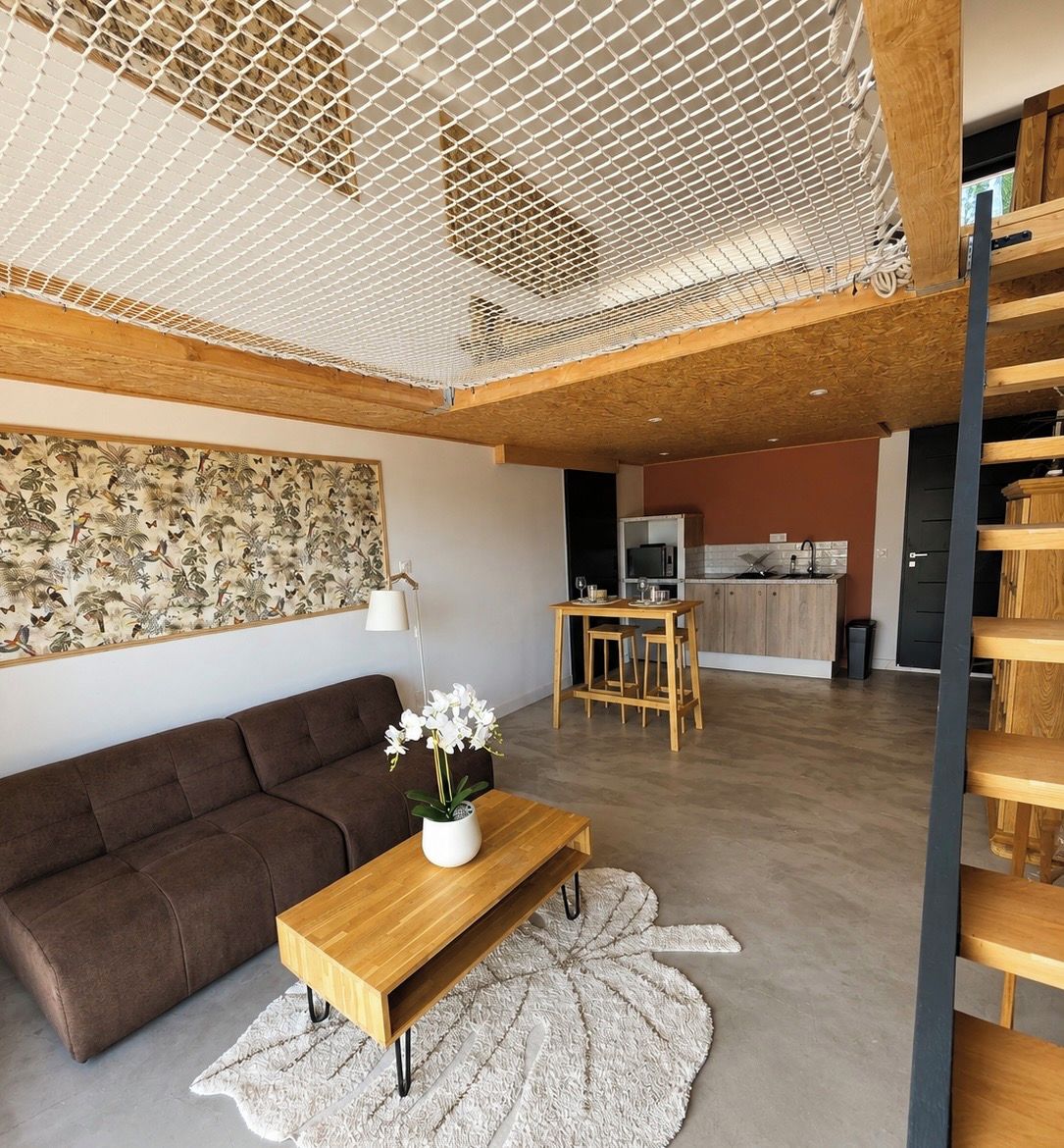 A modern living room with a sofa, a wooden coffee table, and a dining area with a table and chairs.
