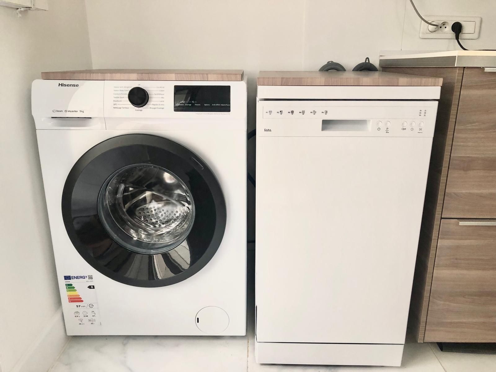 A Hisense washing machine and a dishwasher side by side in a kitchen.