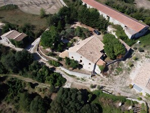 An aerial view of a property with a large building, a smaller structure, and surrounding greenery. - Rural House 'El Masot de Durban' with Mountain Views, Private Terrace and Wi-Fi (Montfalcó Gros)